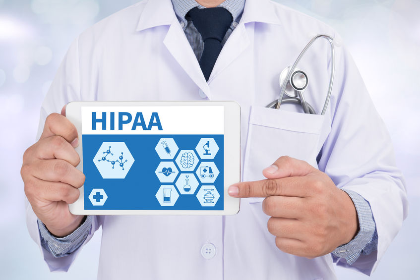 doctor showing tablet with HIPAA regulations
